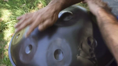 Man playing handpan Stock Footage 95775278
