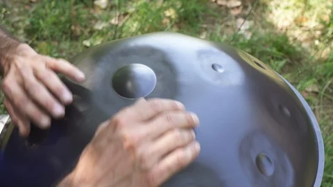 Man playing handpan Stock Footage 95775304