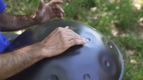 Man playing handpan Stock Footage 95775312