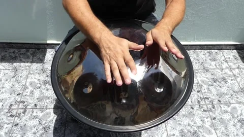 Man playing handpan Stock Footage 168876502