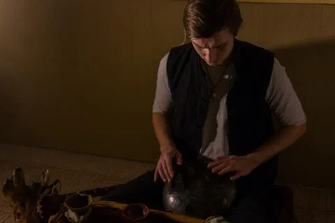 Man playing hang drum Stock Photos