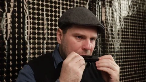 Man playing the harmonica, lifestyle captured through musical performance, .. Stock Footage 292622707