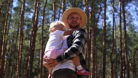 Man playing with his child while walking in the woods. Stock Footage 149946524
