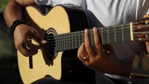 The man is playing his guitar Stock Footage 216583446
