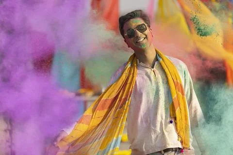 Man playing holi and dancing with gulal on his face Stock Photos