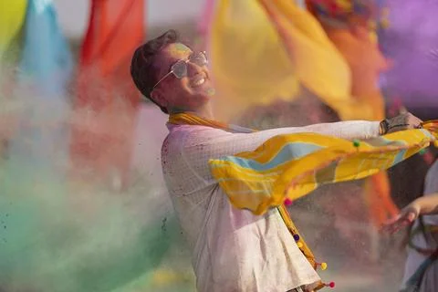 Man playing holi and dancing with gulal on his face Stock Photos