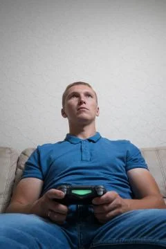 Man playing on the joystick in a game console Foto stock