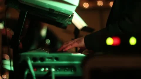 Man playing keyboard at live event with DJ lighting Stock Footage 11136425