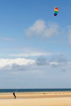 Man playing with a kite at the beach Stock Photos