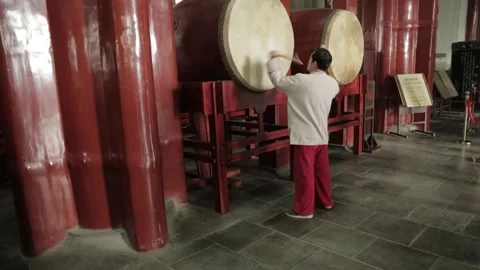 Man Playing Large Traditional Drums Indoors at the Drum and Bell Tower Beijing Stock Footage 341711785