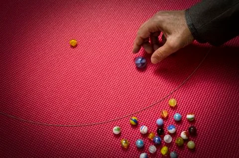Man playing marbles 5 Stock Photos