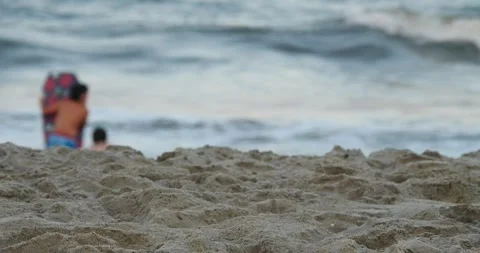 Man playing in the ocean waves at the beach during sunset Stock Footage 281818461