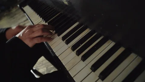 Man playing old piano Stock Footage 105260177
