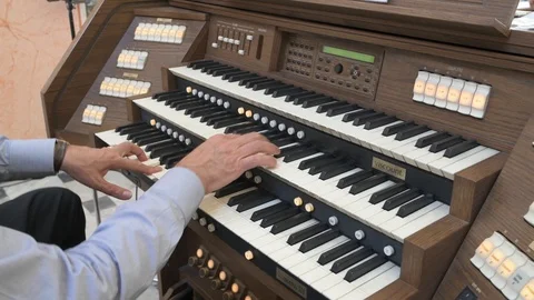 Man playing organ Stock Footage 89974587