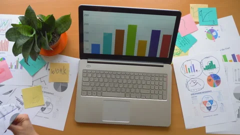 Man playing with paper plane at office surrounded by a lot of paperwork top view Stock Footage 87782053
