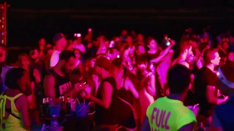 Man playing with phone at full moon party Stock Footage 83875598