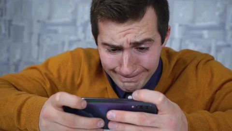 Man playing on the phone while sitting at the table Stock Footage 145344624