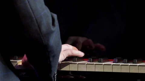 Man playing piano, close-up of right hands on keys 스톡 동영상 101160227