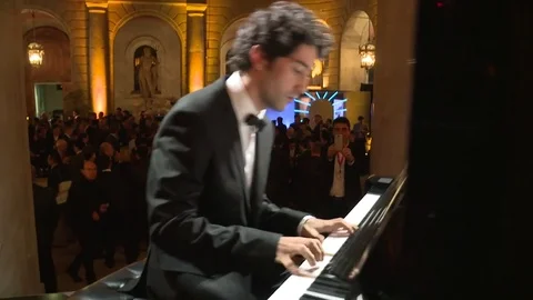 Man playing piano at event Stock Footage 73900540