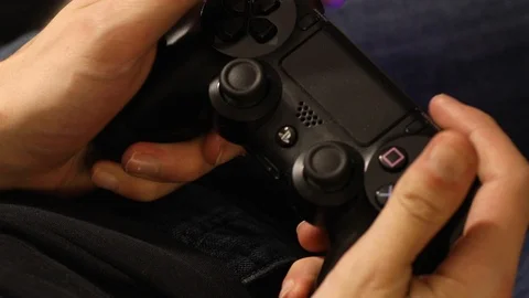 Man is playing Play Station with remote control Stock Footage 126700880