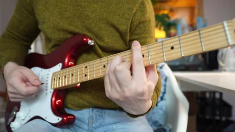 A man playing a red double cut electric guitar. Close up Stock Footage 340904109