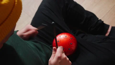 Man playing red tank HAPI drum with sticks Video stock 231801625