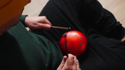 Man playing red tank HAPI drum with sticks Video stock 232666505