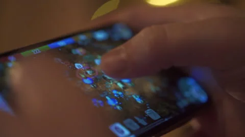 Man Playing RPG Game on his Smartphone while resting at Home on a Couch Stock Footage 197482678