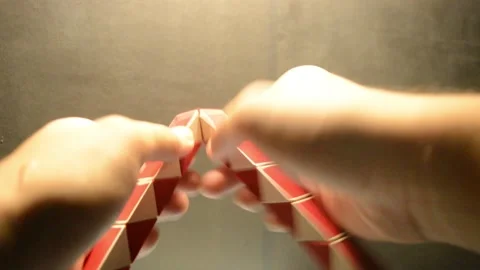 Man playing rubik twist making a ball shape fast Video stock 276409607