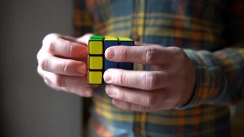 Man playing with Rubik's cube Stock Footage 159546928