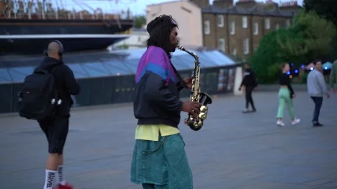 A man playing saxophone at Cutty Sark  in London Greenwich England UK Stock Footage 165454696