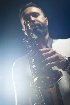 Man playing saxophone on stage during concert Stock Photos