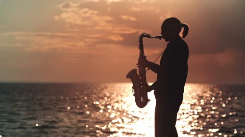 Man playing the saxophone at sunset Video stock 64259725
