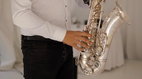 Man playing  the saxophone at a wedding in a nice restaurant. Saxophone player. Stock Footage 128448615