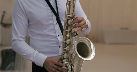 Man playing  the saxophone at a wedding in a nice restaurant.  Stock Footage 130048815
