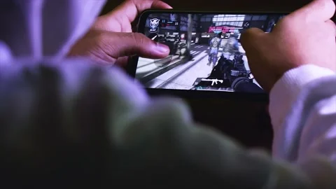 A Man Playing a Shooting Game With a Smartphone. Stock Footage 170154553