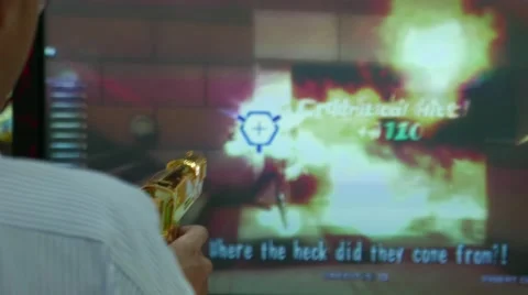 Man Playing a Shooting Games in Arcade, Gateway Ekkamai Mall, Bangkok, Thailand Stock Footage 51991914