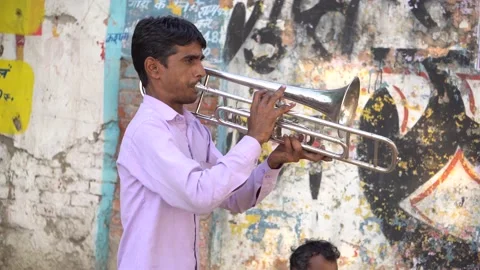 Man playing silver colored trumpet performing his art 動画素材 217534148