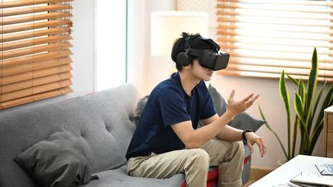 Man playing simulation game with virtual reality headset. Future technology Foto stock