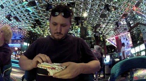 Man playing slots in casino Stock Footage 26555115