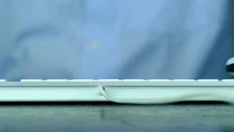 A man is playing a small white car on computer keyboard. Stock-Footage 130477516