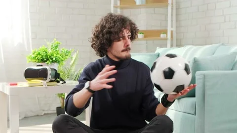 Man playing with soccer ball in front of the camera on bright room background. Stock Footage 154308245