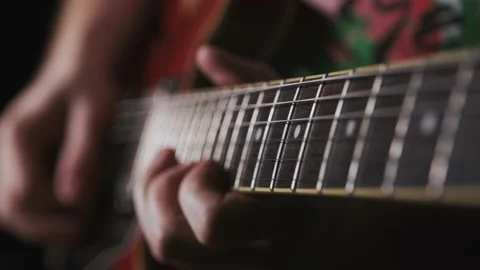 A man is playing solo on red guitar Stock Footage 157609937