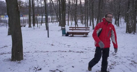 Man is Playing With Somebody Throws The Snow Waves the Hand Invites to a Game Stock Footage 59005309