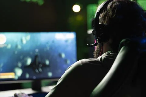 Man playing space exploration simulation game, wearing headset 写真素材