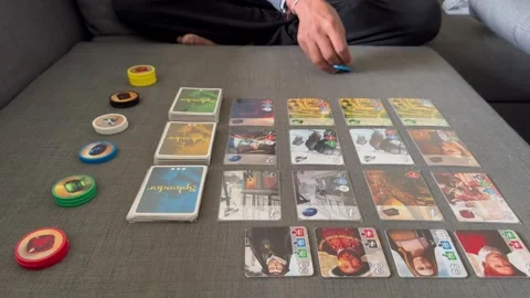 Man playing Splendor board game Stock Footage 269130806