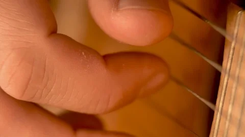 A man is playing the strings of a classical guitar Stock Footage 120306319