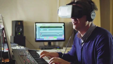 A man playing the synth via virtual reality glasses Stock Footage 72445033