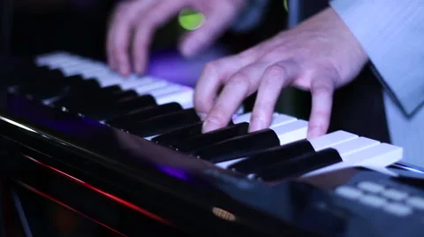 Man playing on synthesizer Stock Footage 58164075
