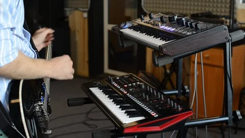 Man playing synthesizer, keyboard and guitar Stock Footage 101114055